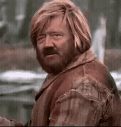 Man With Beard And Long Blonde Hair By Building GIF