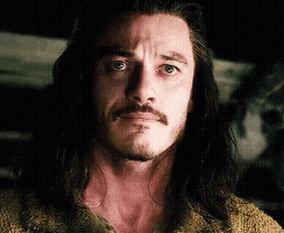 Man With Beard And Long Hair Looking At Camera GIF