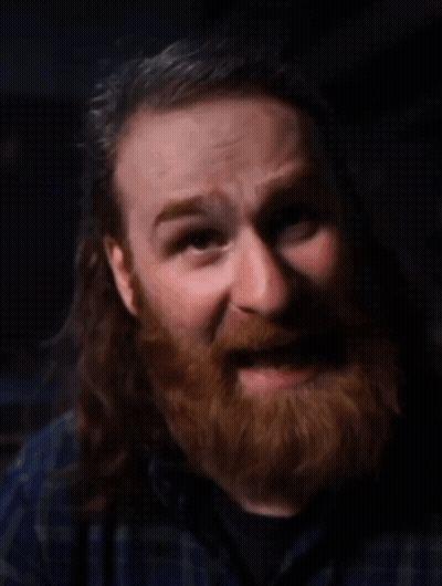 Man With Beard And Long Hair Looking At Camera GIF
