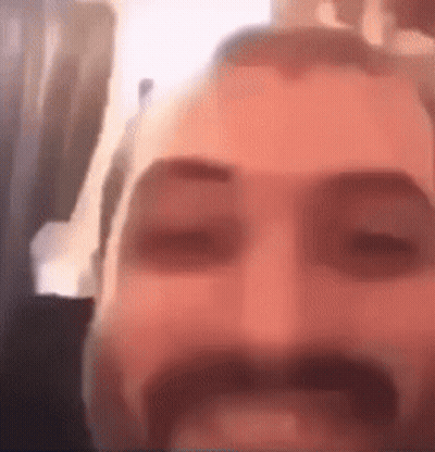 Man With Beard And Mustache Eyes Closed Looking At Camera GIF