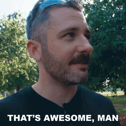 Man With Beard And Mustache Standing In Front Of Trees, Caption That's Awesome Man GIF