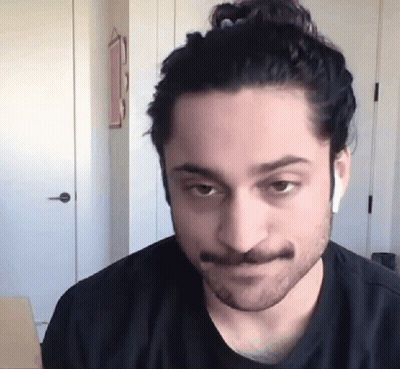 Man With Beard And Mustache Wearing Earbuds GIF