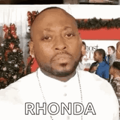 Man With Beard And Necklace In Front Of Christmas Tree GIF