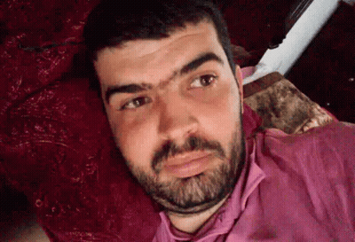 Man With Beard And Pink Shirt Lying On Bed GIF