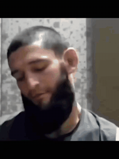 Man With Beard And Shaved Head Looking Down GIF