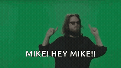 Man With Beard And Sunglasses Waving Saying Mike Hey Mike GIF