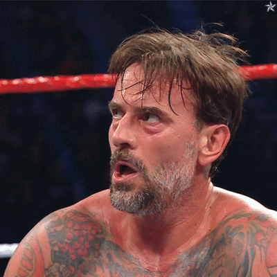 Man With Beard And Tattoos In Boxing Ring With Mouth Open GIF