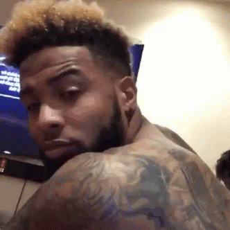 Man With Beard And Tattoos Looking Back GIF