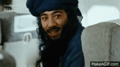 Man With Beard And Turban Smiling On Plane GIF