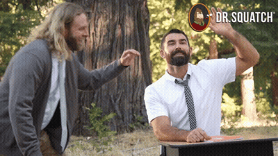 Man With Beard At Desk With Dr. Squatch Sign GIF