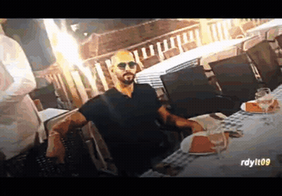 Man With Beard At Table With Plates And Wine Glasses GIF