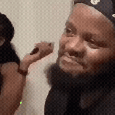 Man With Beard Brushed By Woman GIF