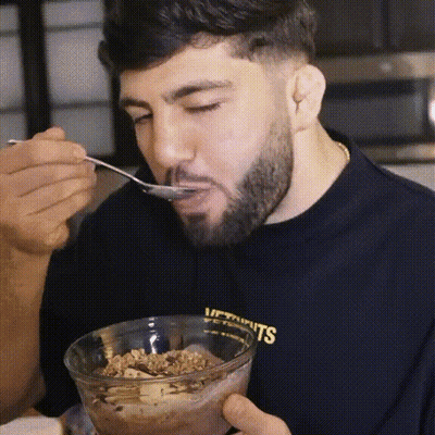 Man With Beard Eating Cereal From Glass Bowl GIF