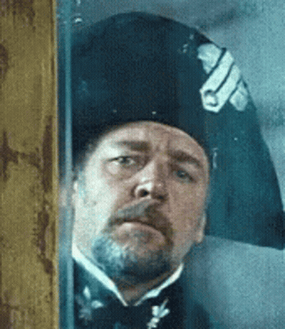 Man With Beard, Hat, Bow Tie At Window GIF