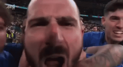 Man With Beard Held By Group GIF