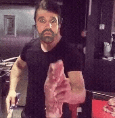 Man With Beard Holding Meat GIF