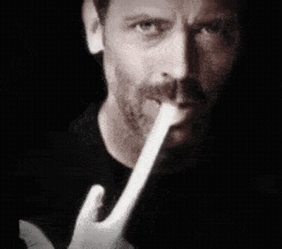 Man With Beard Holding Paper In Mouth GIF