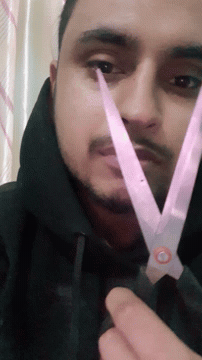 Man With Beard Holding Scissors To Face GIF