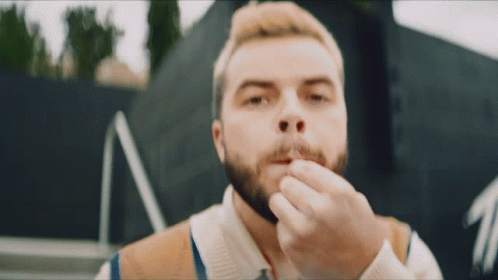 Man With Beard Holding Something In His Mouth GIF
