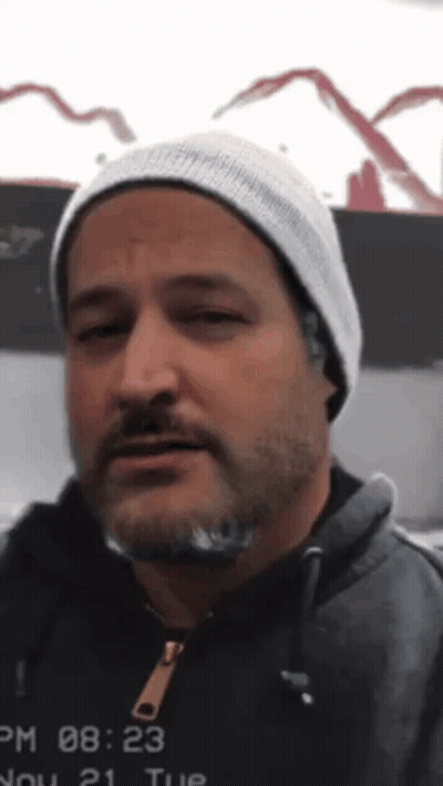 Man With Beard In Beanie And Hoodie At 08:23 GIF