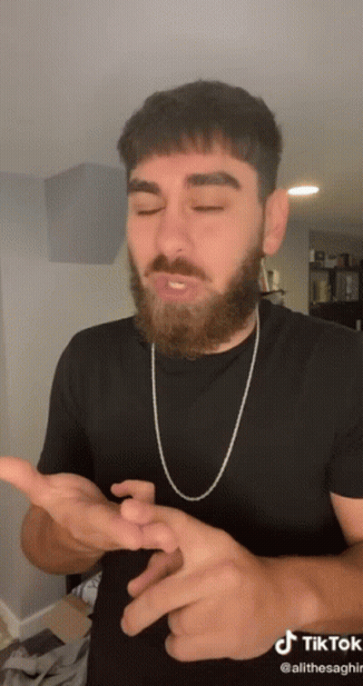 Man With Beard In Black Shirt And Chain GIF
