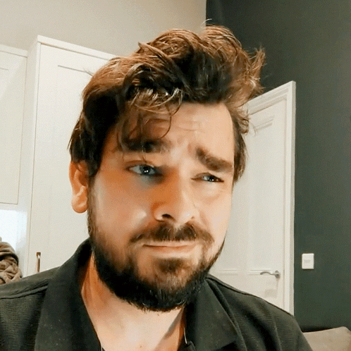 Man With Beard In Black Shirt Making Funny Face GIF