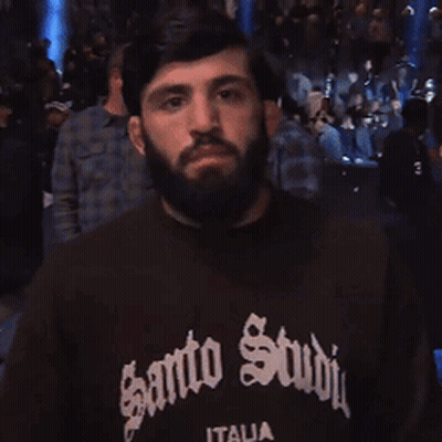 Man With Beard In Black Shirt Saying Santo Studio GIF