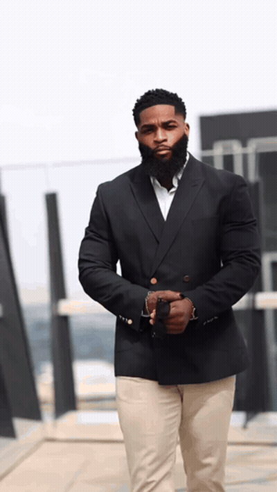 Man With Beard In Black Suit And Khaki Pants GIF
