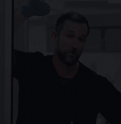 Man With Beard In Blue Glove And Black Shirt GIF