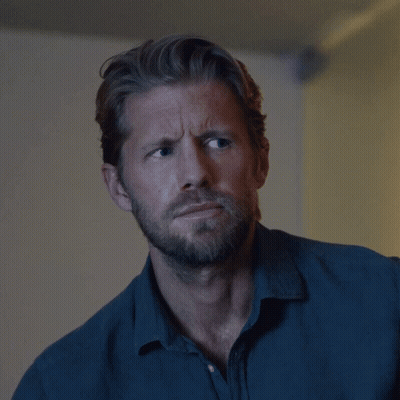 Man With Beard In Blue Shirt Looking At Camera GIF