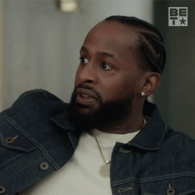 Man With Beard In Denim Jacket And Necklace Looking GIF