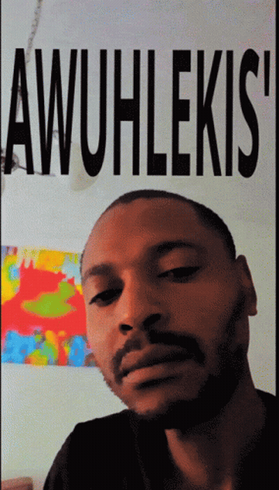 Man With Beard In Front Of Awuhlekis Poster GIF
