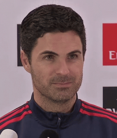 Man With Beard In Front Of Emirates Banner GIF
