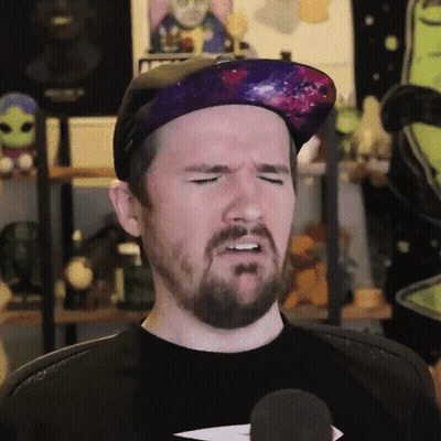 Man With Beard In Galaxy Hat And Black Shirt GIF