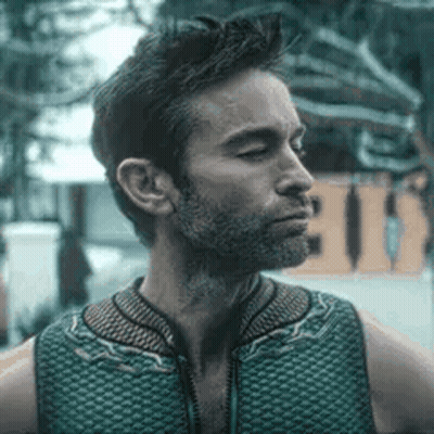 Man With Beard In Green Vest Looking Sideways GIF