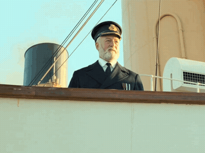 Man With Beard In Hat And Tie On Boat GIF