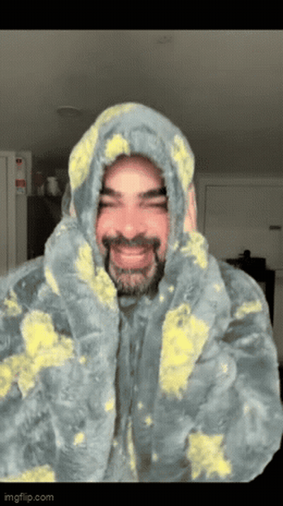 Man With Beard In Hooded Blanket GIF