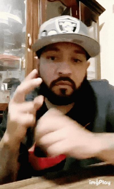 Man With Beard In Raiders Hat Flipping Off GIF