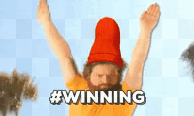 Man With Beard In Red Hat And Yellow Shirt Raising Arms GIF