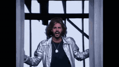 Man With Beard In Silver Jacket And Necklace GIF
