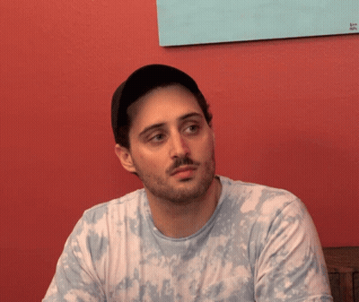 Man With Beard In Tie Dye Shirt And Hat GIF