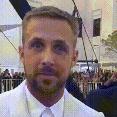 Man With Beard In White Suit And Tie Before Crowd GIF