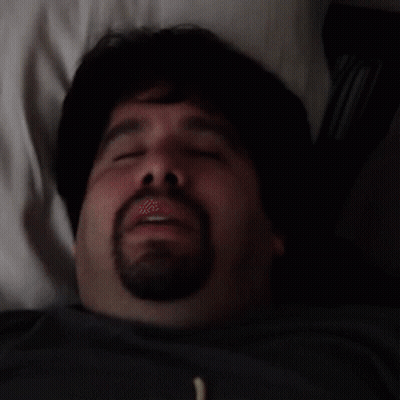 Man With Beard Laying In Bed Eyes Closed Mouth Open GIF