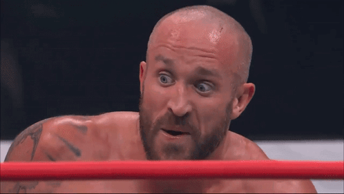 Man With Beard Laying In Boxing Ring Mouth Open GIF