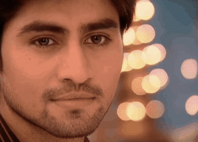 Man With Beard Looking At Camera Blurry Lights GIF