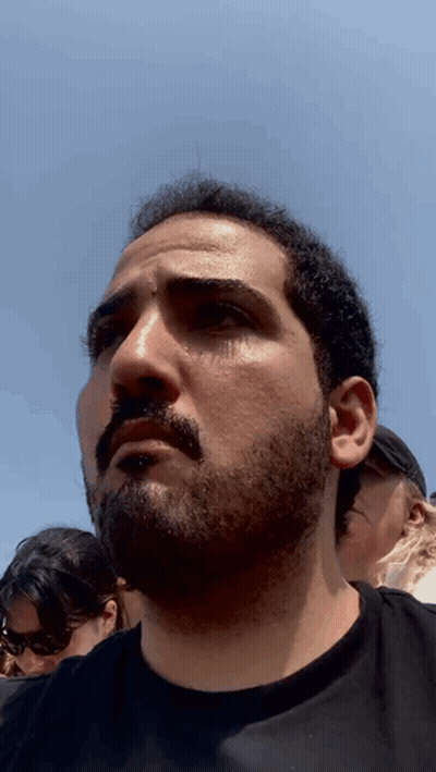 Man With Beard Looks At Camera GIF