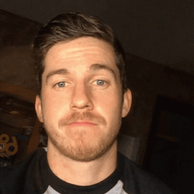 Man With Beard Making Funny Face In Dark Room GIF