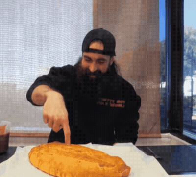 Man With Beard Pointing At Loaf Of Bread GIF