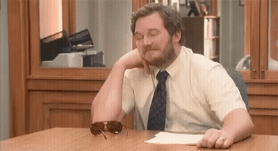 Man With Beard Sitting At Desk With Sunglasses GIF