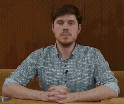 Man With Beard Sitting At Table GIF